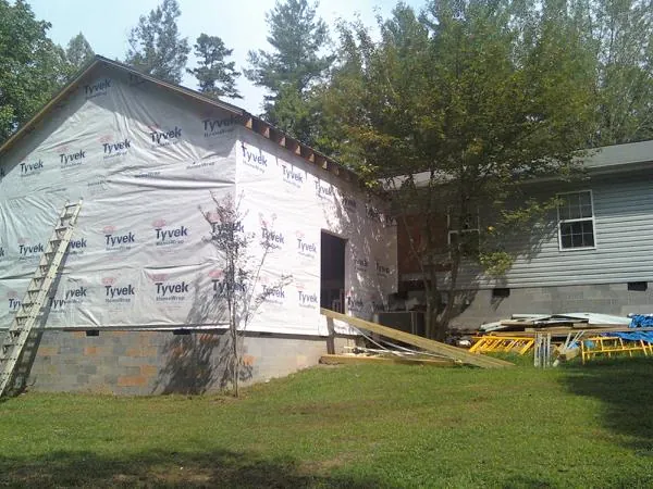 Tyvek wrapped gable on a new room addition beside an existing home in Huntly